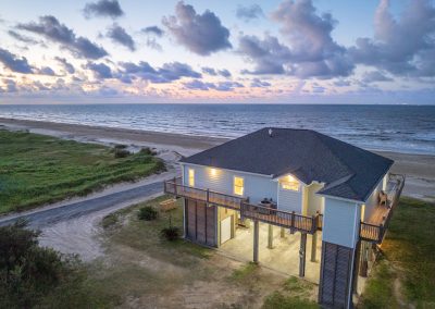 841 Buell Street, Crystal Beach, Texas, 77650, Owner Edward White, Photographed at daybreak, located on the Gulf of America. The house has 3 bedrooms, 2 full baths, laundry room, kitchen, living room dining room, deck, parking area underneath, downstairs shower and view of the beach and Gulf.