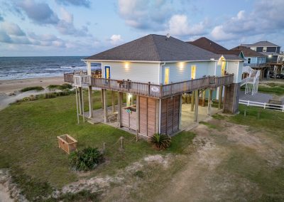 841 Buell Street, Crystal Beach, Texas, 77650, Owner Edward White, Photographed at daybreak, located on the Gulf of America. The house has 3 bedrooms, 2 full baths, laundry room, kitchen, living room dining room, deck, parking area underneath, downstairs shower and view of the beach and Gulf.