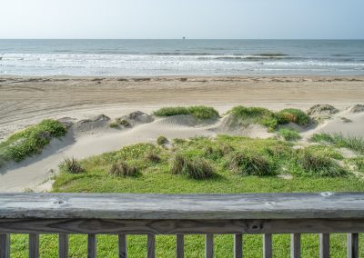 841 Buell Street, Crystal Beach, Texas, 77650, Owner Edward White, View of the sand dunes and Gulf from the second floor deck in early morning light. The house has 3 bedrooms, 2 full baths, laundry room, kitchen, living room dining room, deck, parking area underneath, downstairs shower and view of the beach and Gulf. off of balcony